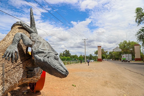 Sculptures of giant iguanas at the entrance to the town , one of the Yaquis communities in  Mexico. town of iguanas.  photo