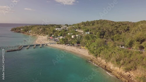 Aerial View of Crash Boat Beach, Borinquen, Aguadilla, Puerto Rico. Scenic Coast and Vegetation by Caribbean Sea on Sunny Day, Drone Shot photo