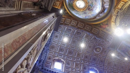 Indoor ceiling view of Basilica di San Pietro in Rome, Italy, beautiful gold finishing photo