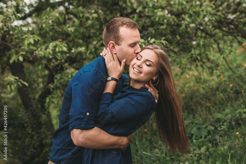 Portrait of a happy couple have fun in the spring garden. Strong family relationships of a couple in love