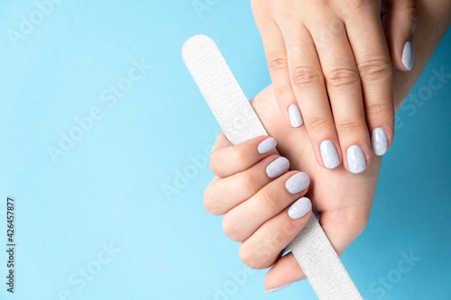 Manicure. Gray nails. Design - crumb on nails. Light fashionable manicure on female hands.