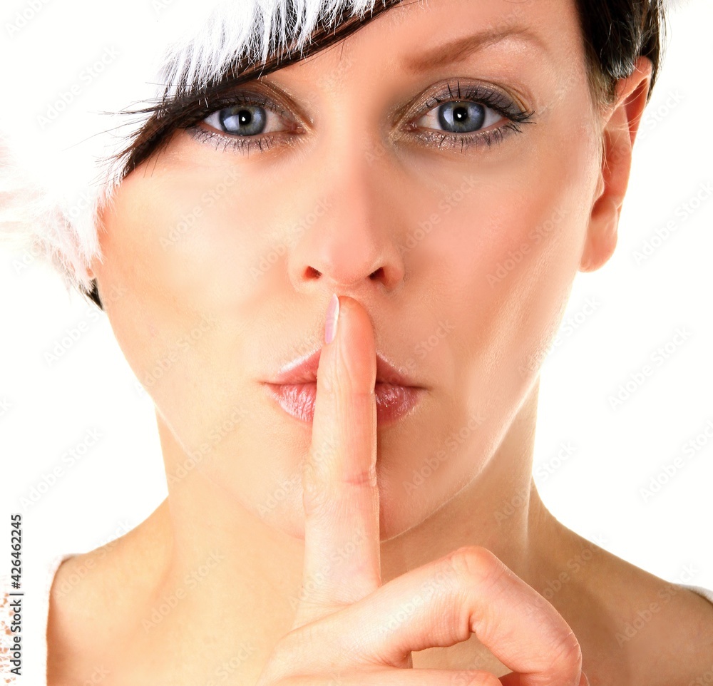 woman with fingers over mouth showing the quiet hand gesture stock photo woman with fingers over mouth showing the quiet hand gesture stock photo
