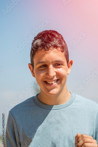 young boy in light blue sweater smiling
