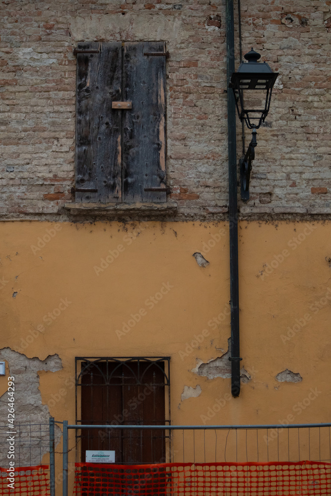 abandoned house with brick facades and closed windows, Italy