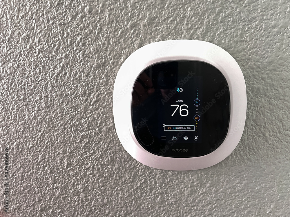An Ecobee smart thermostat in a home. foto de Stock | Adobe Stock
