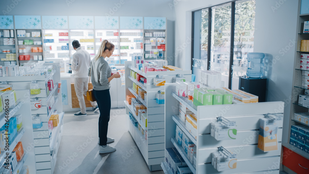 Pharmacy Drugstore: Beautiful Young Woman Chooses to Buy Medicine, Drugs, Vitamins, Searches for the Best Choice. Modern Pharma Store Shelves with Health Care, Beauty Products