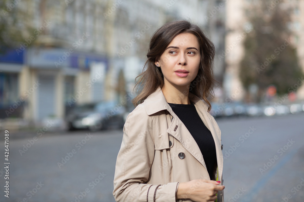 Stylish brunette woman wears trench
