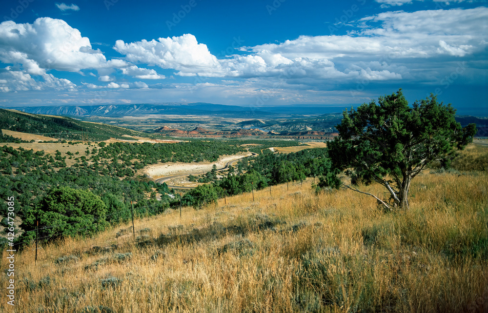Vast landscape, valley with highway, rock formations and reservoir, Utah
