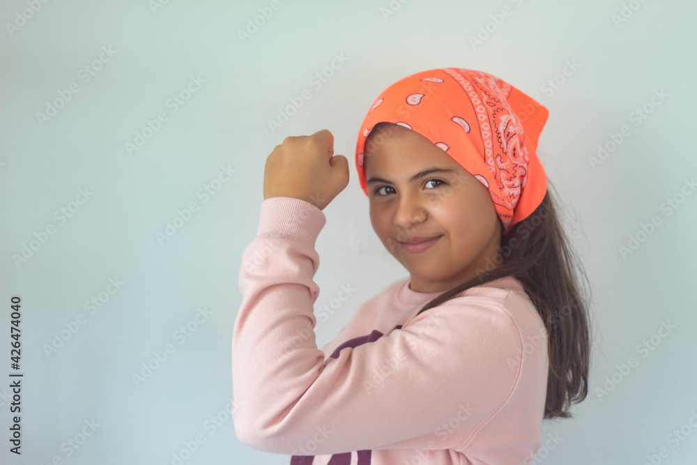 Beautiful and strong little woman with scarf showing biceps. Left arm raised Beautiful and strong little woman with scarf showing biceps. Left arm raised