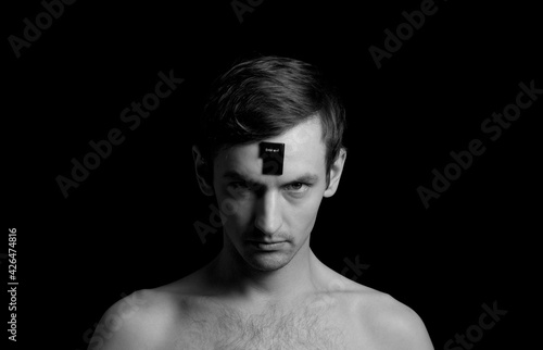 black and white photo portrait of a guy, button on the forehead