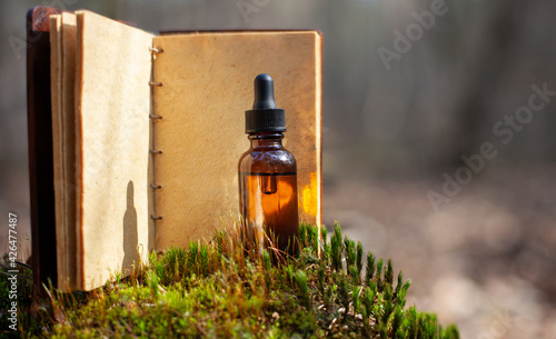 Essential oil bottle and aromatherapy, blank old notebook.