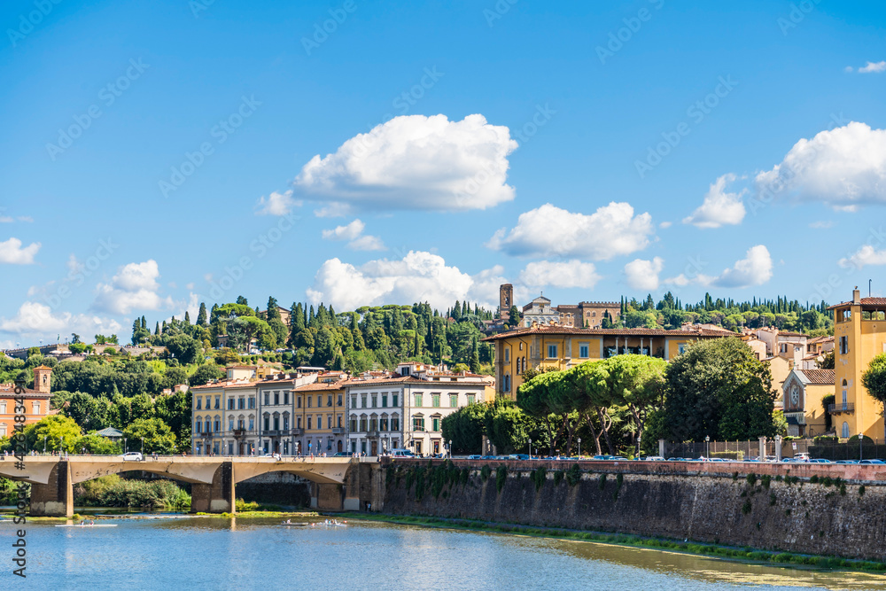 The river Arno and the buildings along Lungarno Serristori, on the background the Basilica of San Miniato al Monte, Florence city center, Tuscany, Italy