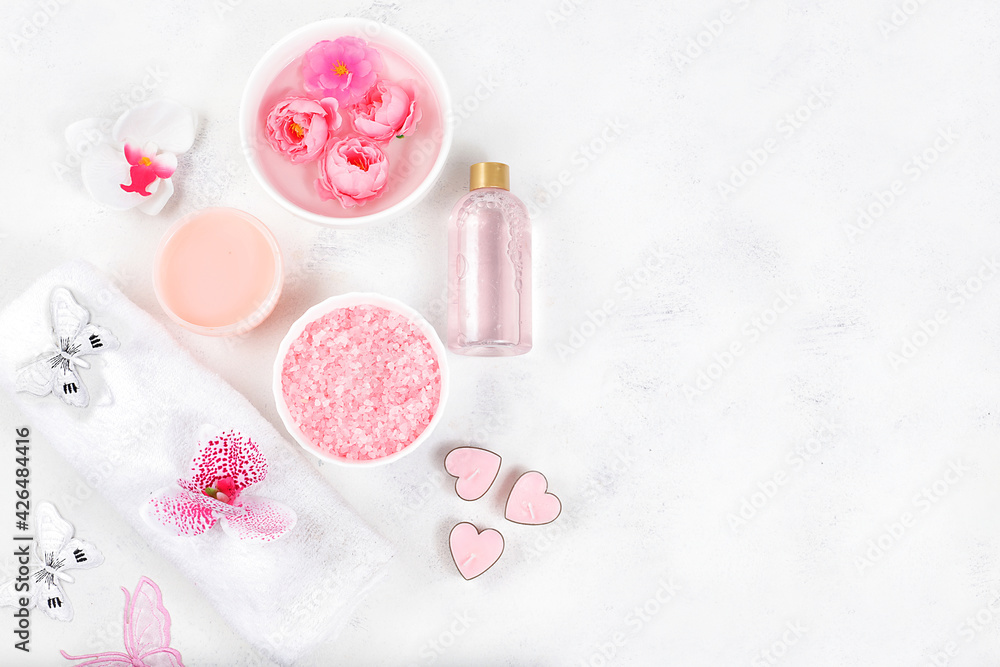 Spa and wellness composition with aromatic rose water, salt, roses and sakura, towels, aromatherapy and skin care, lifestyle concept, invitation and advertising card, selective focus Spa and wellness composition with aromatic rose water, salt, roses and sakura, towels, aromatherapy and skin care, lifestyle concept, invitation and advertising card, selective focus
