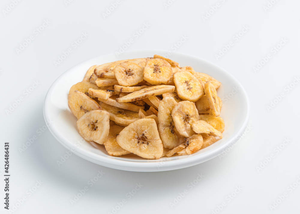 Homemade dried bananas close-up on a light background. Homemade candied fruits. Homemade dried bananas close-up on a light background. Homemade candied fruits.