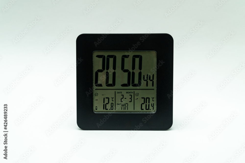 Black alarm clock, with weather station isolated on a white background Black alarm clock, with weather station isolated on a white background