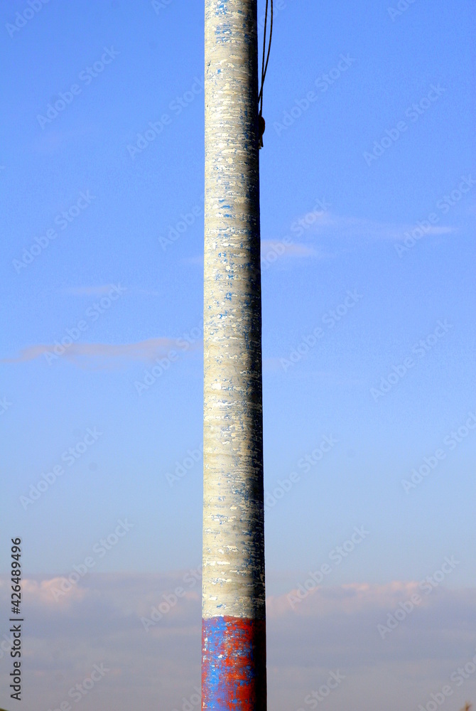 Chromatic effect of colors of the metal pole with the blue sky background