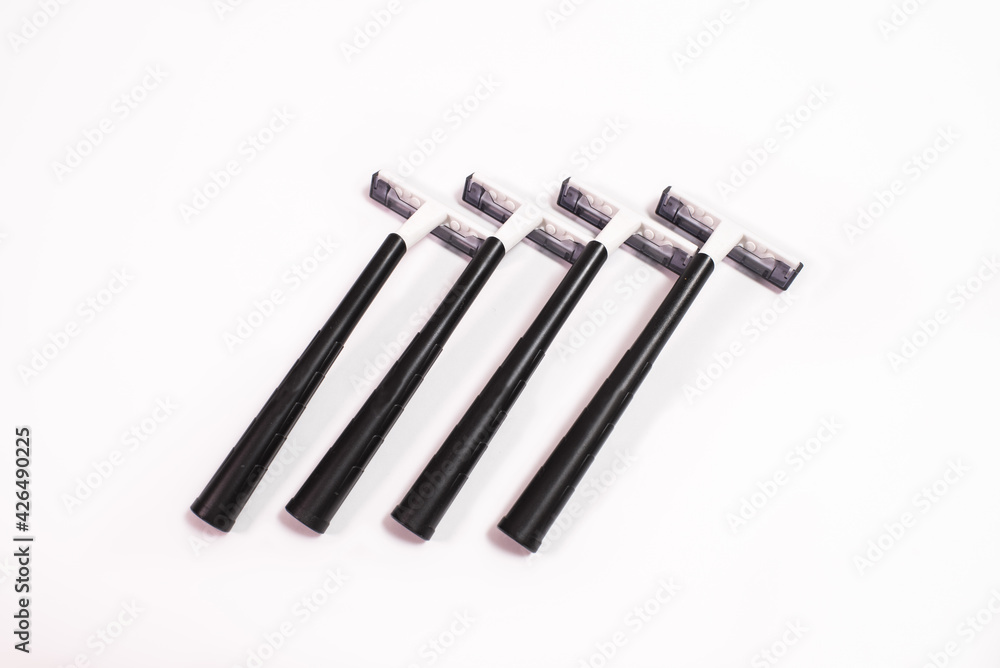Four black disposable razors isolated on white background Four black disposable razors isolated on white background