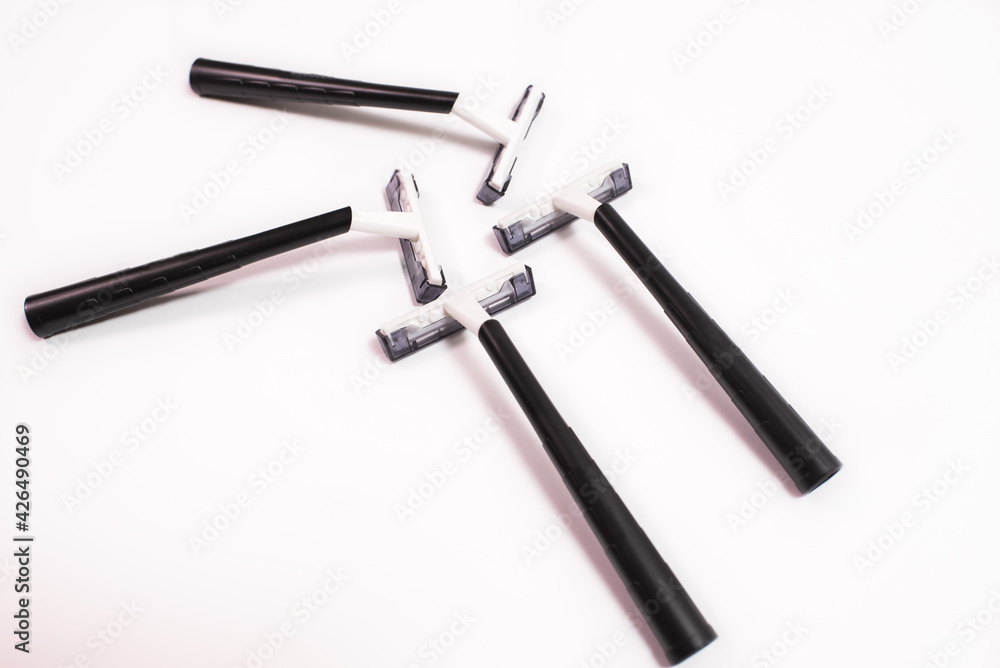 Four black disposable razors isolated on white background Four black disposable razors isolated on white background