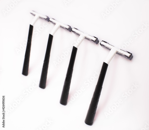 Four black disposable razors isolated on white background