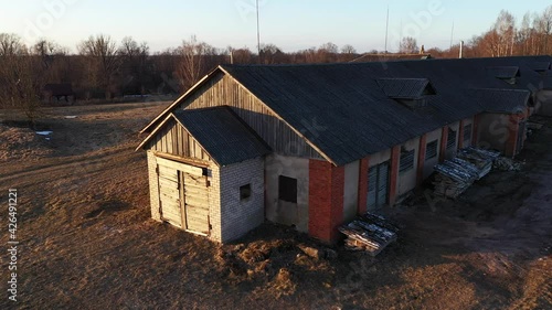 Old Abandoned Brick Farmhouse with Wood Piles Outside, Aerial Parallax View