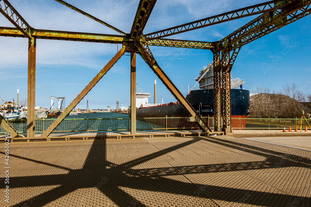 A self unloading dry-bulk carrier (ship) using it's boom arm to unload ...