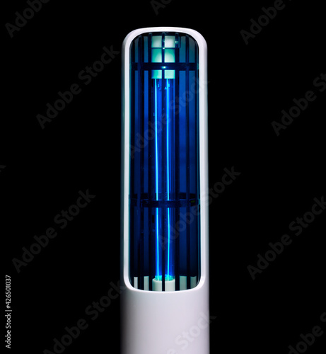 Working bactericidal lamp in white plastic case on black background