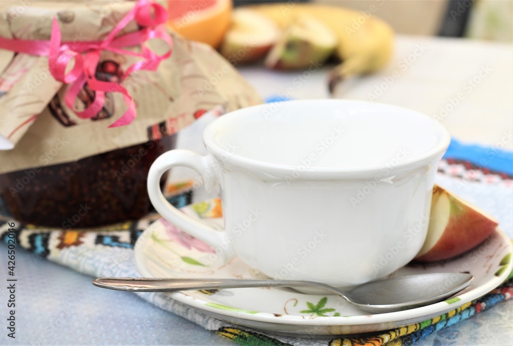 white cup of tea with sweet berries jam and fruits white cup of tea with sweet berries jam and fruits