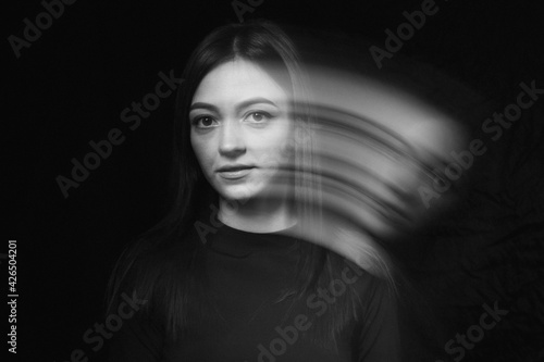 Blurred female portrait in the dark.