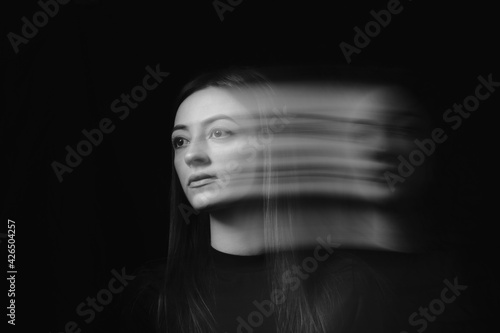 Blurred female portrait in the dark.