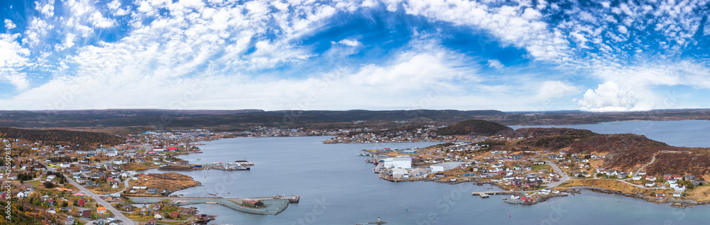 Aerial panoramic view of a town on the Rocky Atlantic Ocean Coast. Colorful Blue Sky Art Render. Taken in St. Anthony, Newfoundland, Canada.