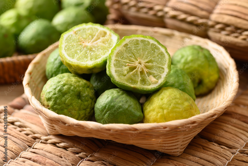Fresh bergamot fruit in a basket, Food ingredients and extract used for medicine, tea, perfumes and cosmetics - obrazy, fototapety, plakaty 