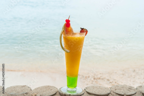 Exotic summer drink. Blur beach as background