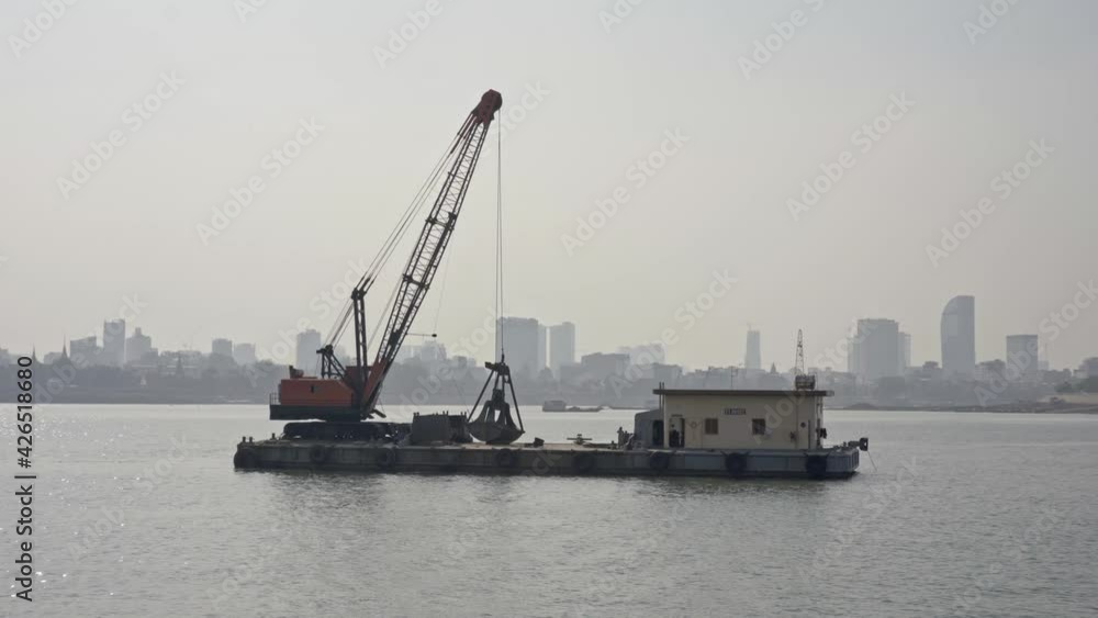 Backhoe on a floating platform, Mekong River.