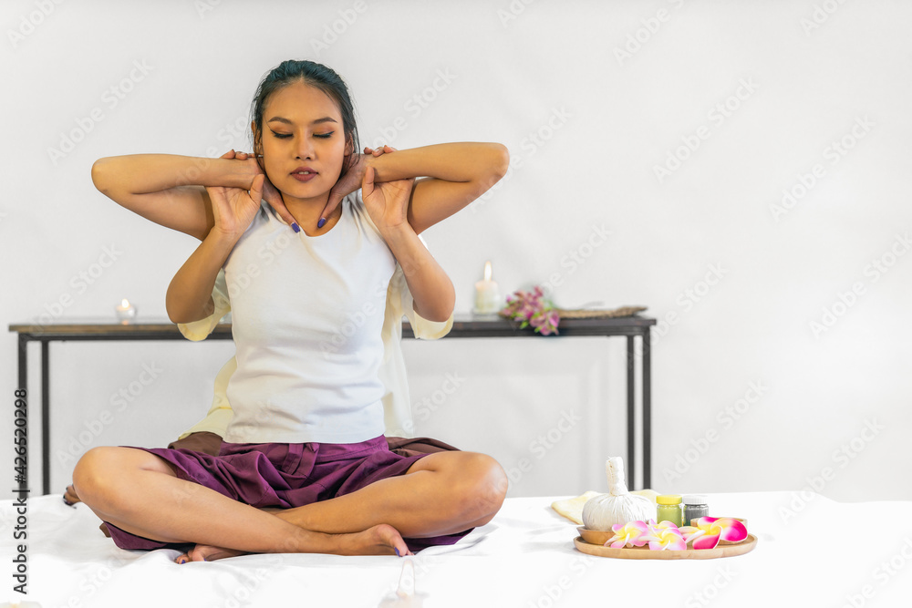 asian woman has Thai massage therapy of neck and shoulder stretching asian woman has Thai massage therapy of neck and shoulder stretching