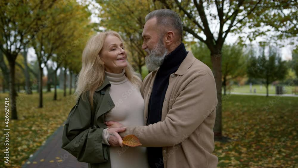 Happy couple hugging in autumn park. Close up romantic lovers talking. Happy couple hugging in autumn park. Close up romantic lovers talking.