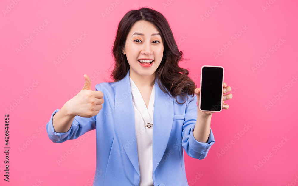 Asian businesswoman using smartphone on pink background Asian businesswoman using smartphone on pink background