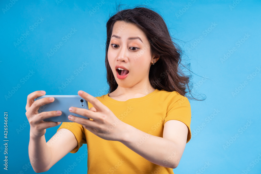 Beautiful Asian woman playing game on phone Beautiful Asian woman playing game on phone