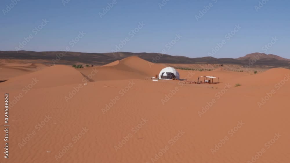 Traditional Camping Tent On Sand Dunes Of Erg Chebbi. Merzouga Luxury Desert Camp In Morocco. POV, revealing shot Traditional Camping Tent On Sand Dunes Of Erg Chebbi. Merzouga Luxury Desert Camp In Morocco. POV, revealing shot