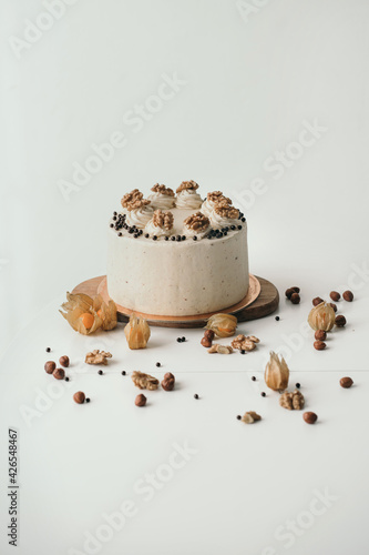 Vertical frame homemade birthday cake Beautiful cake with walnuts. Chocolate sponge cake with cream cheese and nuts