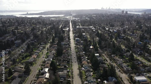 Cinematic aerial drone dolly shot of Cowen Park, Roosevelt, Ravenna, Laurelhurst, University District, Lake Washington and downtown Seattle in the distance photo