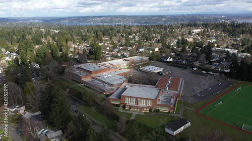 Cinematic aerial drone dolly flyover shot of Eckstein Middle School in Wedgwood, View Ridge, Lavilla, Pontiac, Sand Point with Lake Washington and in the distance photo