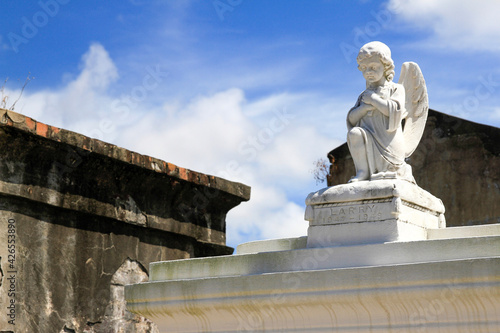 statue of cherub on grave in New Orleans