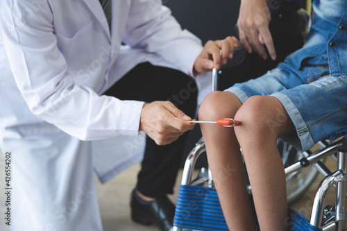 Asian orthopedic doctor checkup knee bone disability wheel chair patient  person , Disability handicap person health concept