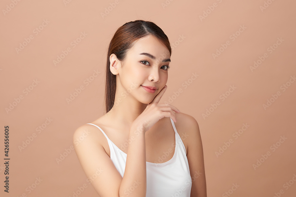 Beautiful young asian woman with clean fresh skin on beige background, Face care, Facial treatment, Cosmetology, beauty and spa, Asian women portrait