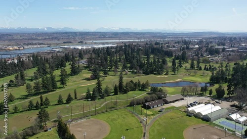 Cinematic aerial drone clip of Northwest Everett, Everett Community College, Legion Memorial Golf Course and nearby bedroom communities with Cascade Range North of Seattle by Puget Sound in Washington photo