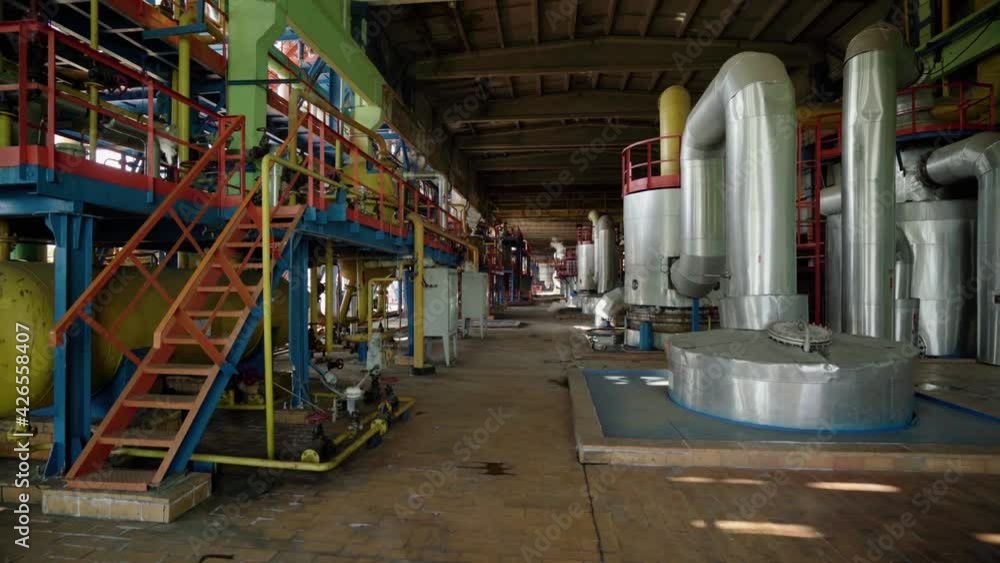 A huge oil refinery with metal structures, pipes and distillation of the complex. Industrial area with chemical plant. Process area structure , piping , engineering equipment A huge oil refinery with metal structures, pipes and distillation of the complex. Industrial area with chemical plant. Process area structure , piping , engineering equipment