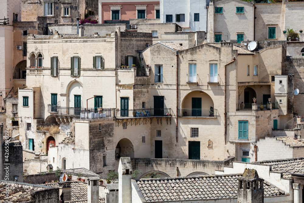 Old stones house buildings and ancient Italian village in Matera in Italy. Full picture of white buildings made with stones. Cluster of houses. Matera, Italy.