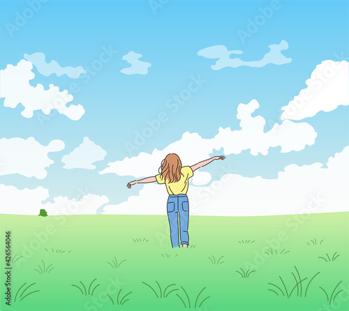 A woman is standing with arms wide open in a clear sky and a wide field. hand drawn style vector design illustrations. 