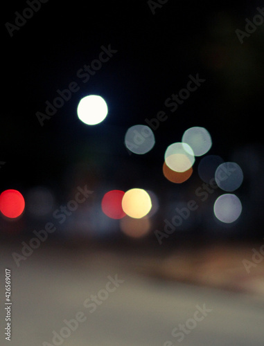 Out of focus defocused blurred bokeh of cars and traffic lights at night on city street. © pentao10