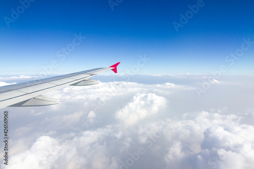 An airplane wing in the sky The sky atmosphere is cloudy and dust is thick. Fly on the Asian continent  Thailand.